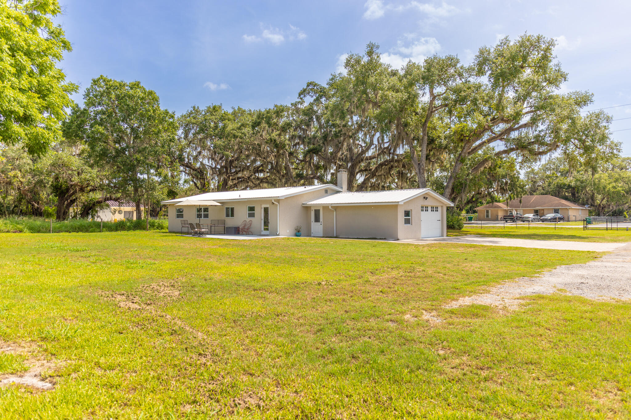 2675 Southwest 24th Avenue Okeechobee, FL 34974 - Photo 19 of 60 a view of a swimming pool with an outdoor seating and a yard