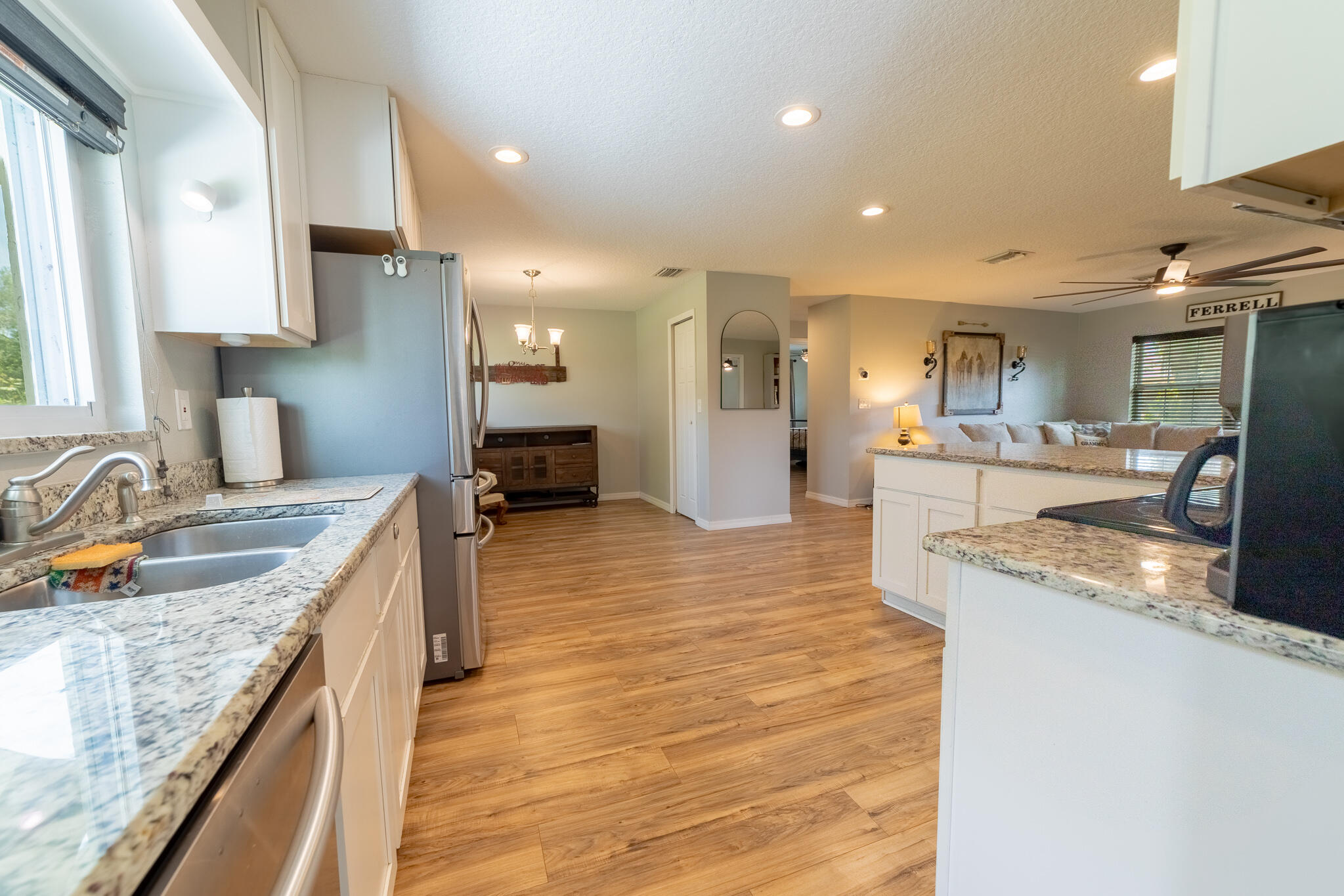 2675 Southwest 24th Avenue Okeechobee, FL 34974 - Photo 28 of 60 a large kitchen with granite countertop a sink and a stove
