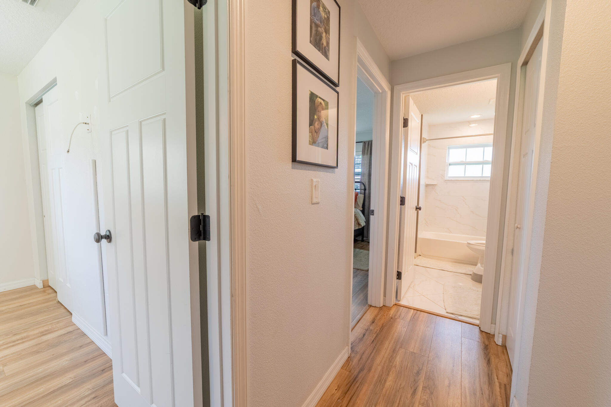 2675 Southwest 24th Avenue Okeechobee, FL 34974 - Photo 29 of 60 a view of a hallway with wooden floor and a bathroom