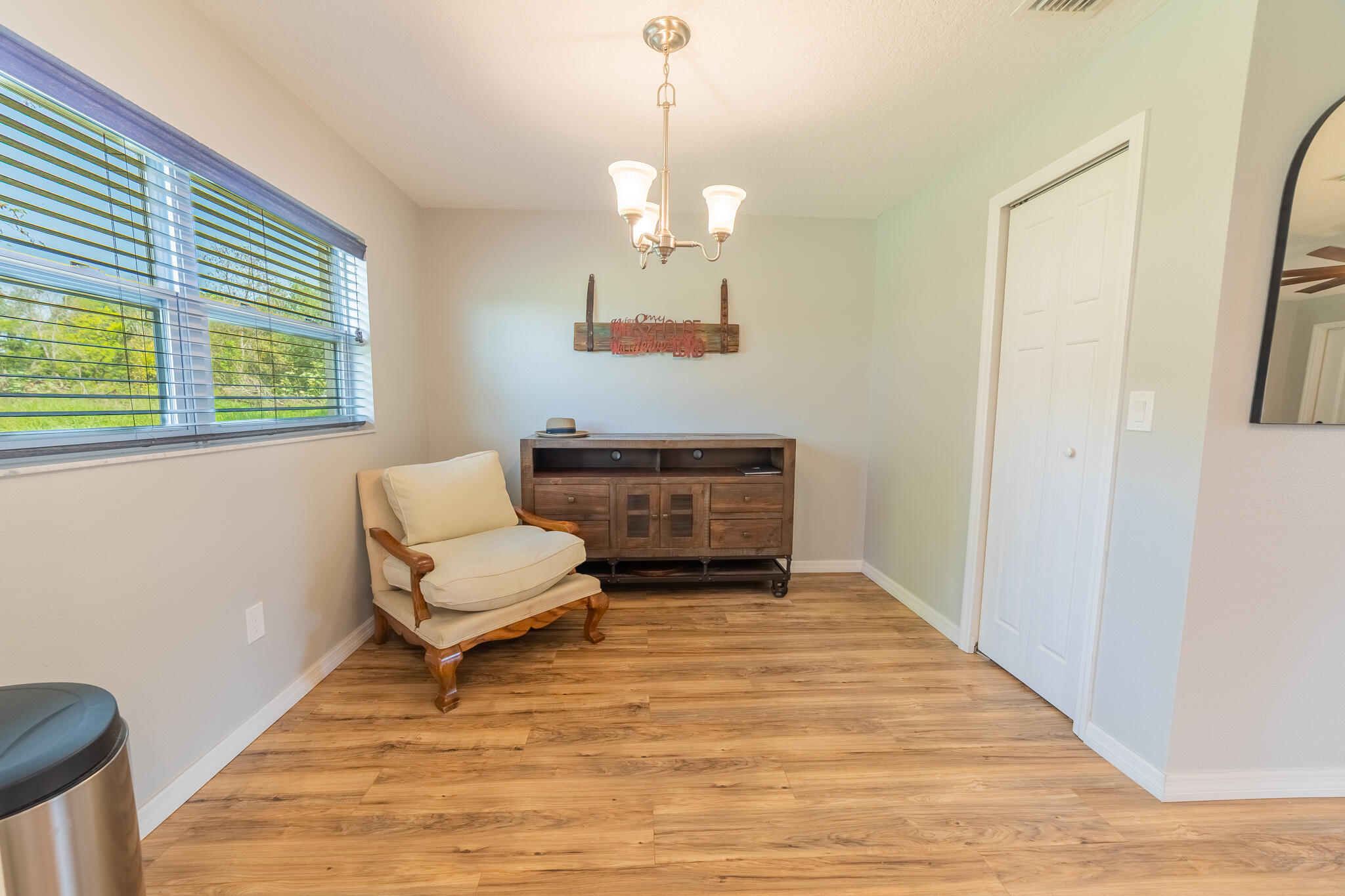 2675 Southwest 24th Avenue Okeechobee, FL 34974 - Photo 40 of 60 a living room with furniture a window and a chandelier
