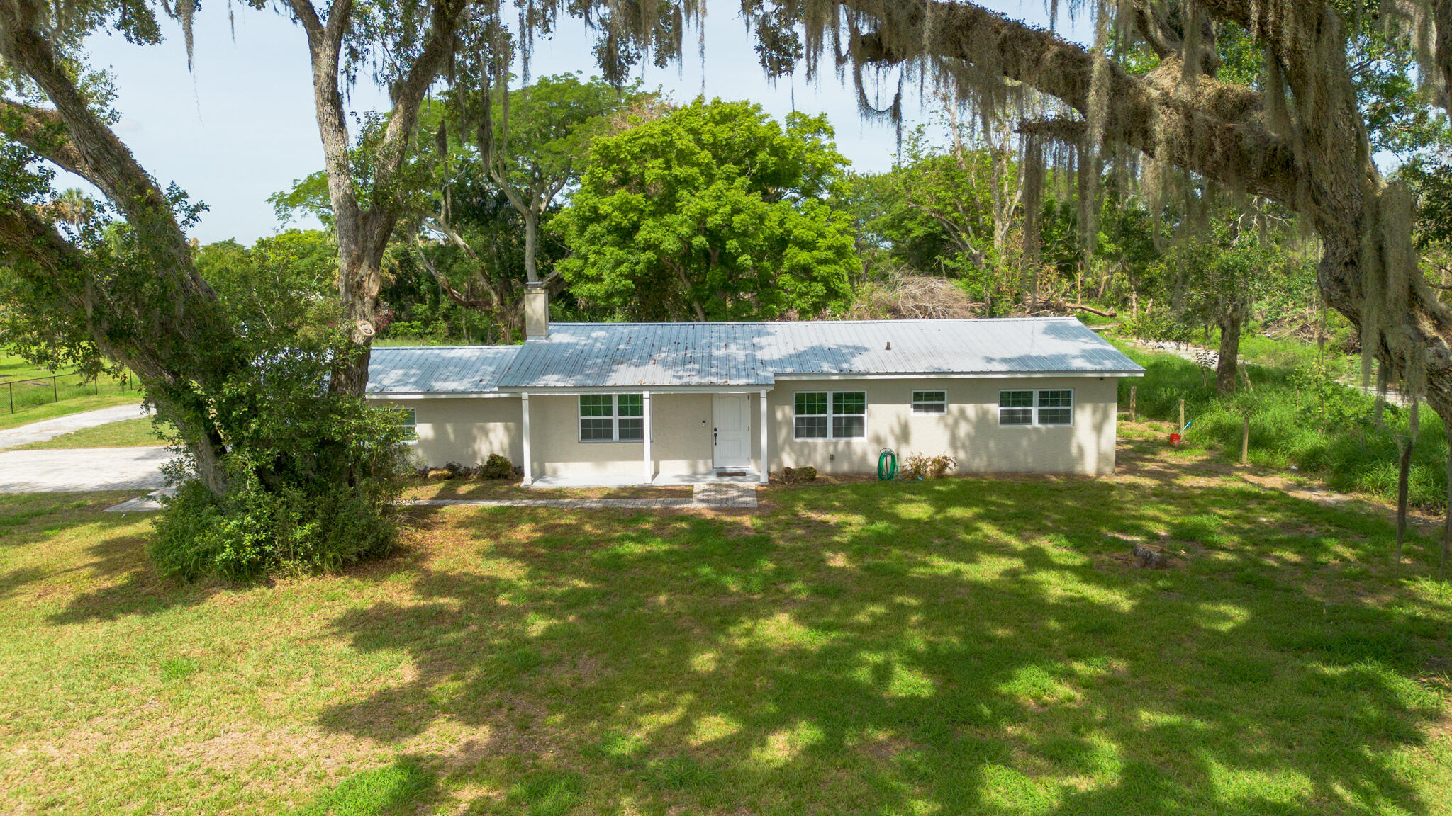 2675 Southwest 24th Avenue Okeechobee, FL 34974 - Photo 5 of 60 a view of a house with garden and a tree