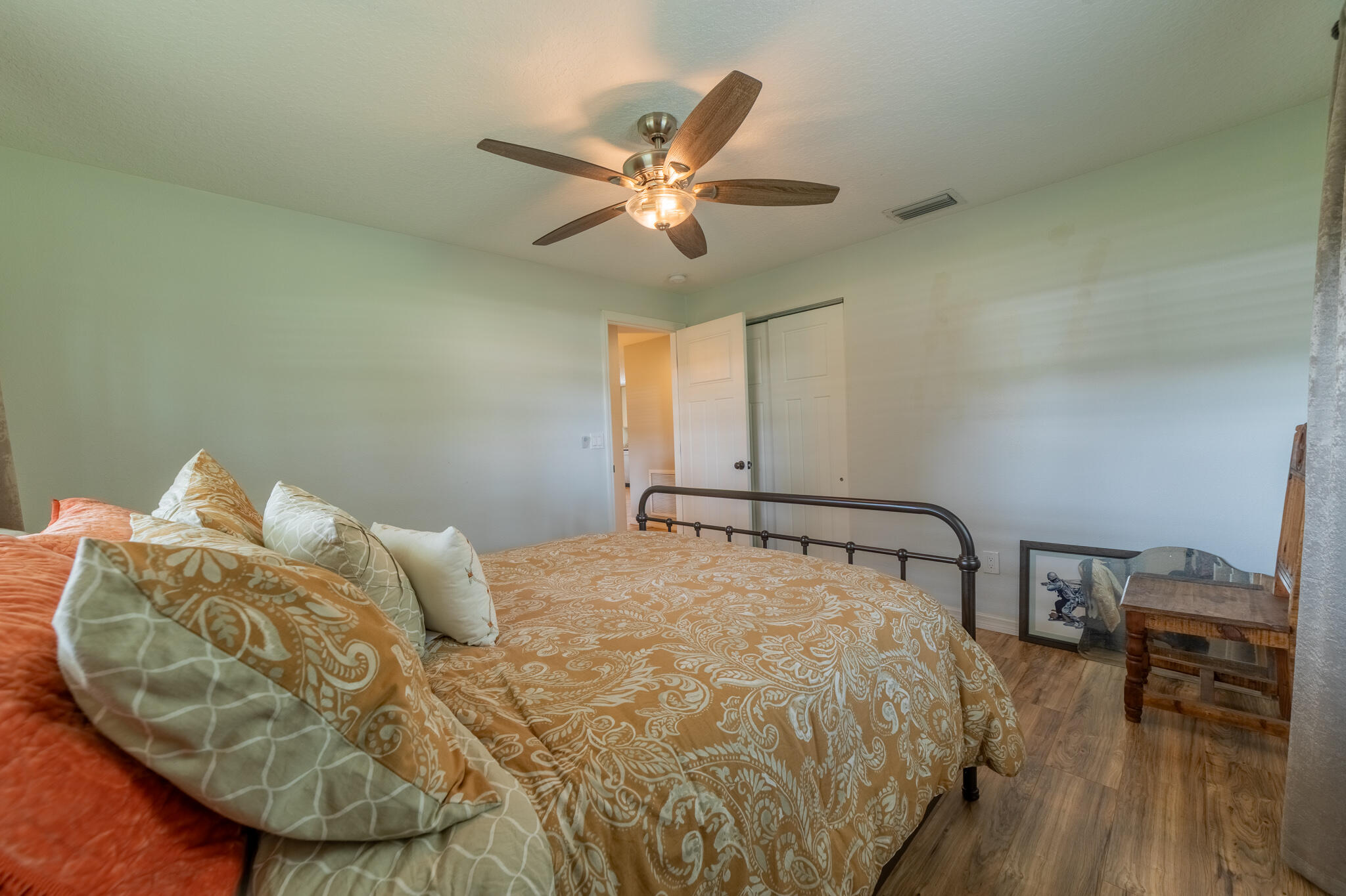 2675 Southwest 24th Avenue Okeechobee, FL 34974 - Photo 51 of 60 a bed sitting in a bedroom next to a window with wooden floor