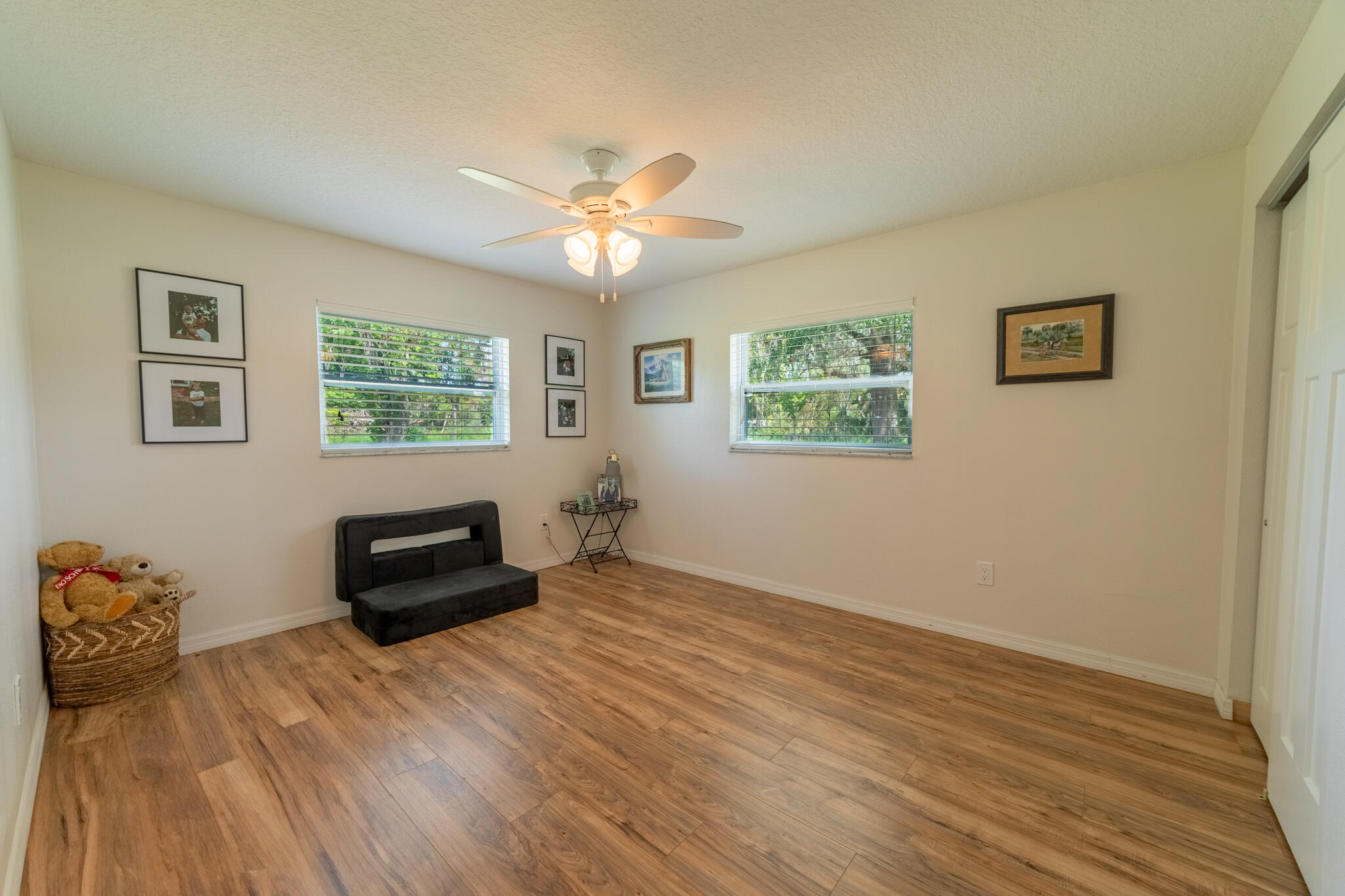2675 Southwest 24th Avenue Okeechobee, FL 34974 - Photo 53 of 60 a view of a livingroom with wooden floor and a ceiling fan