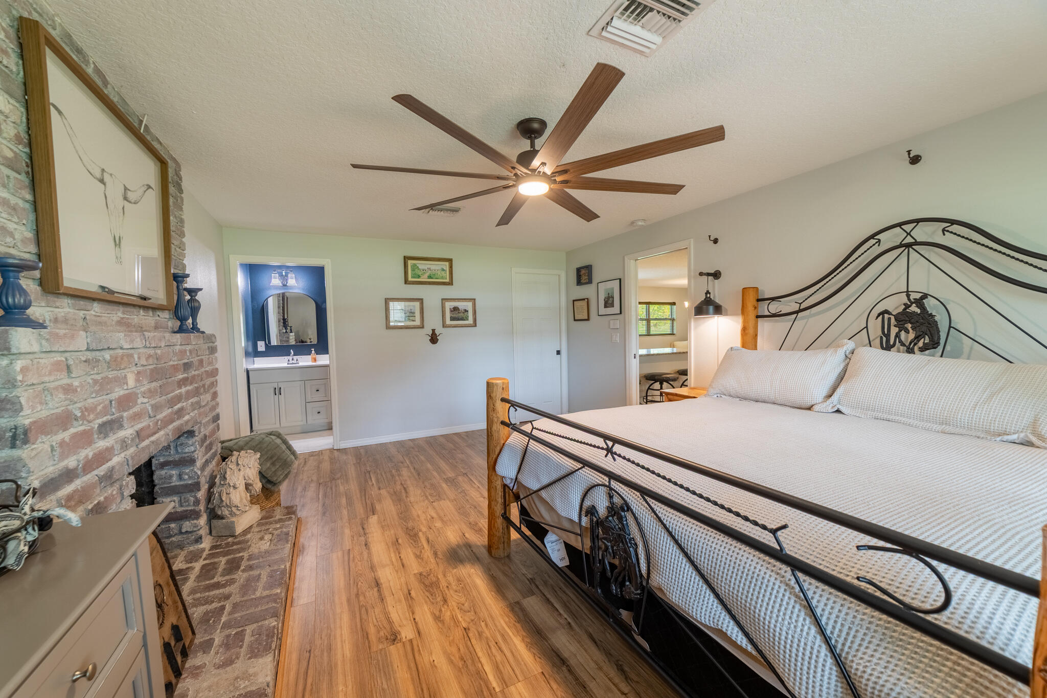 2675 Southwest 24th Avenue Okeechobee, FL 34974 - Photo 59 of 60 a bedroom with a bed and a ceiling fan with wooden floor