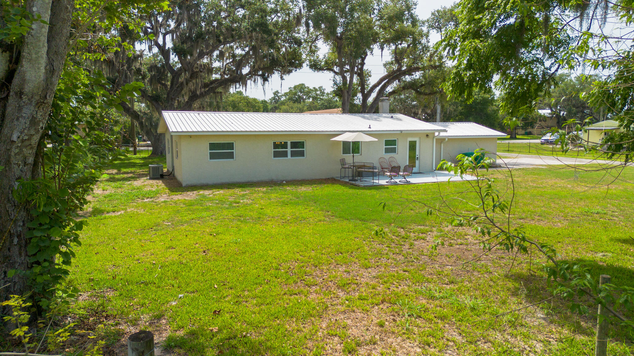 2675 Southwest 24th Avenue Okeechobee, FL 34974 - Photo 9 of 60 a view of a house with a yard and large trees