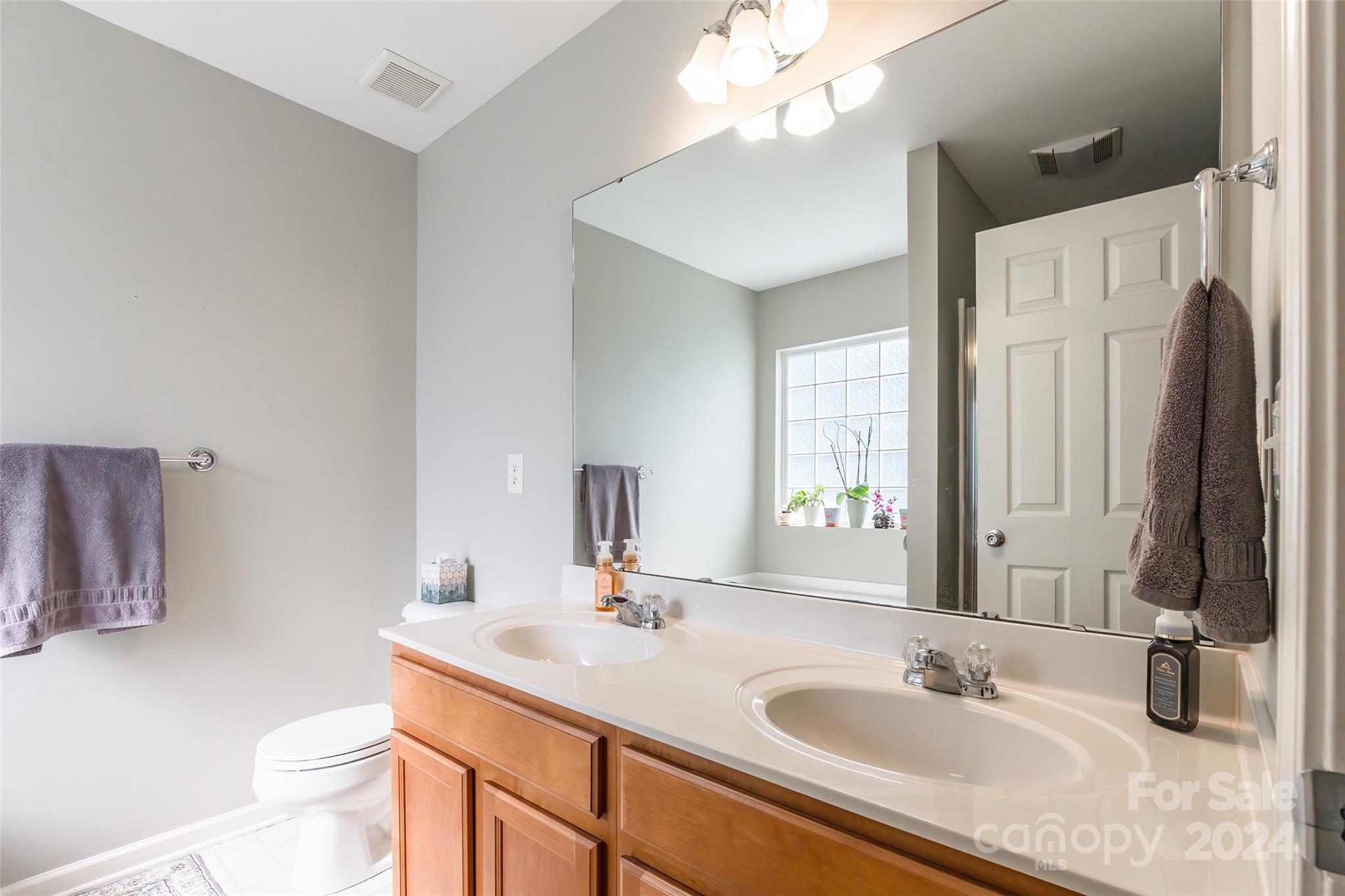 2901 Liddington Road Matthews, NC 28105 - Photo 21 of 37 a bathroom with a sink double vanity granite and a mirror