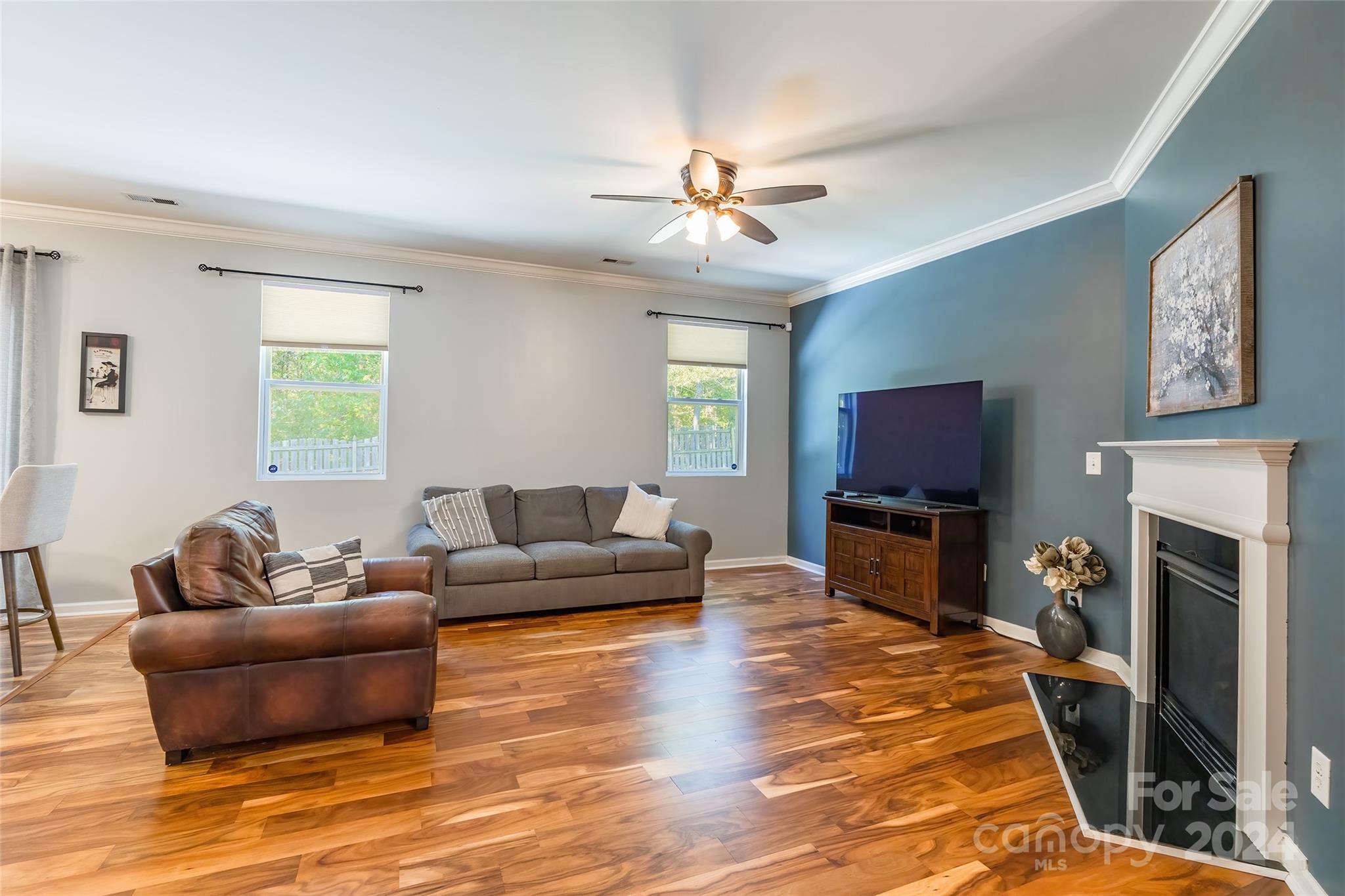 2901 Liddington Road Matthews, NC 28105 - Photo 7 of 37 a living room with furniture a flat screen tv and a fireplace