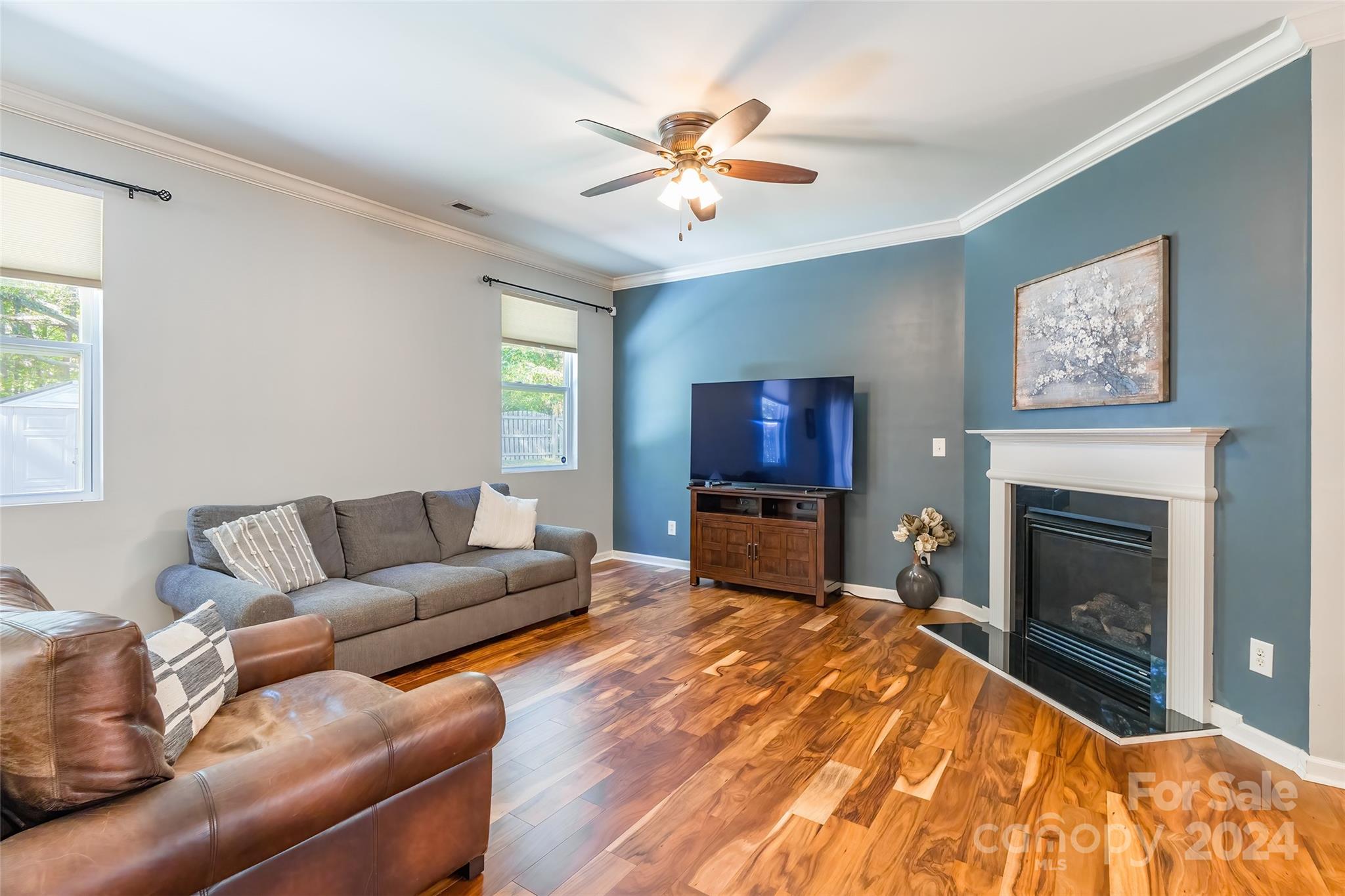 2901 Liddington Road Matthews, NC 28105 - Photo 8 of 37 a living room with furniture a fireplace and a flat screen tv