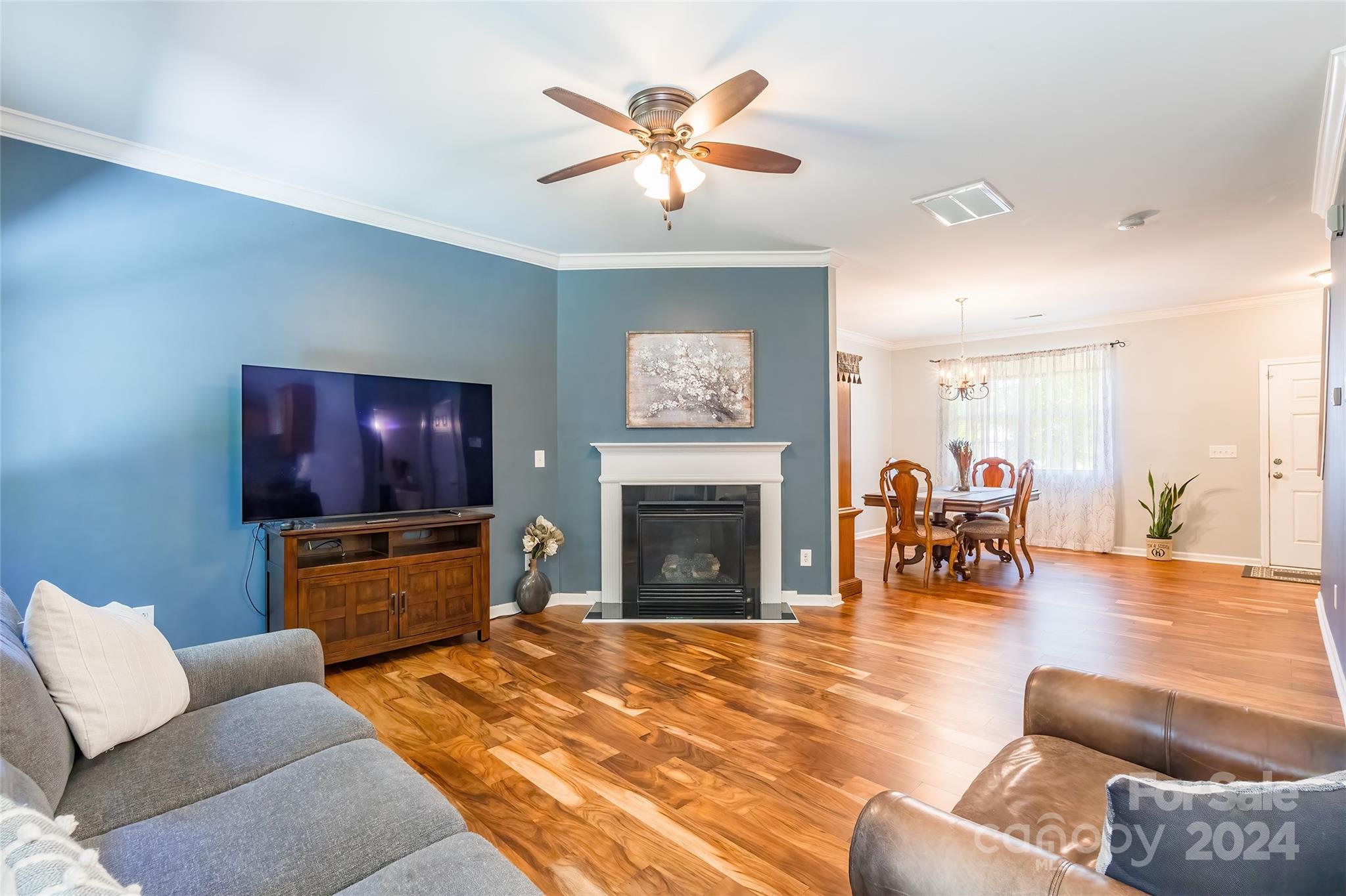 2901 Liddington Road Matthews, NC 28105 - Photo 9 of 37 a living room with furniture a fireplace and a chandelier
