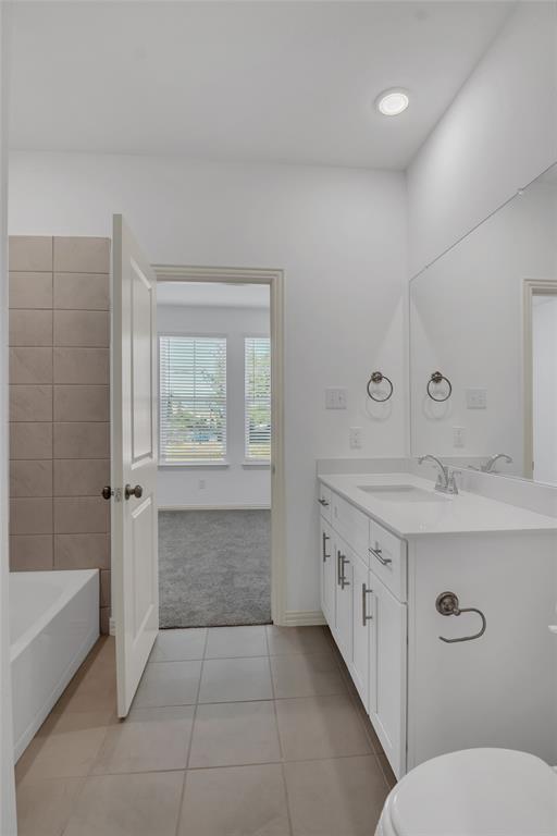 5258 Springlake Parkway Haltom City, TX 76117 - Photo 11 of 24 a bathroom with a granite countertop sink a toilet and bathtub