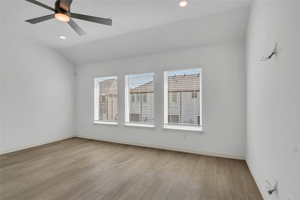 5258 Springlake Parkway Haltom City, TX 76117 - Photo 13 of 24 an empty room with wooden floor fan and windows