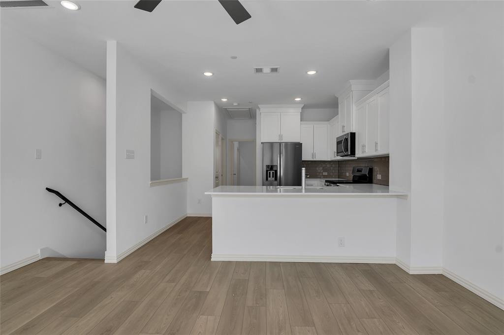 5258 Springlake Parkway Haltom City, TX 76117 - Photo 15 of 24 a view of kitchen with stainless steel appliances refrigerator stove microwave and cabinets