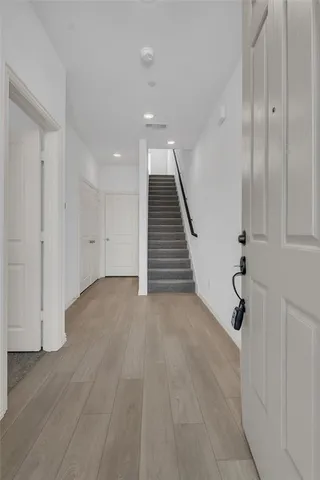 a view of an entryway with wooden floor