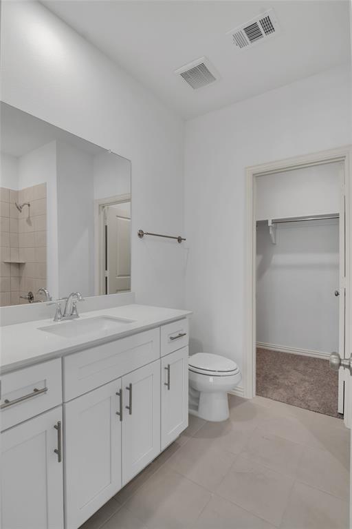 5258 Springlake Parkway Haltom City, TX 76117 - Photo 9 of 24 a bathroom with a granite countertop toilet sink and mirror