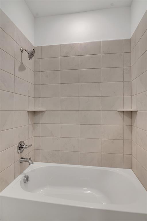 5258 Springlake Parkway Haltom City, TX 76117 - Photo 10 of 24 a bathroom with a bathtub