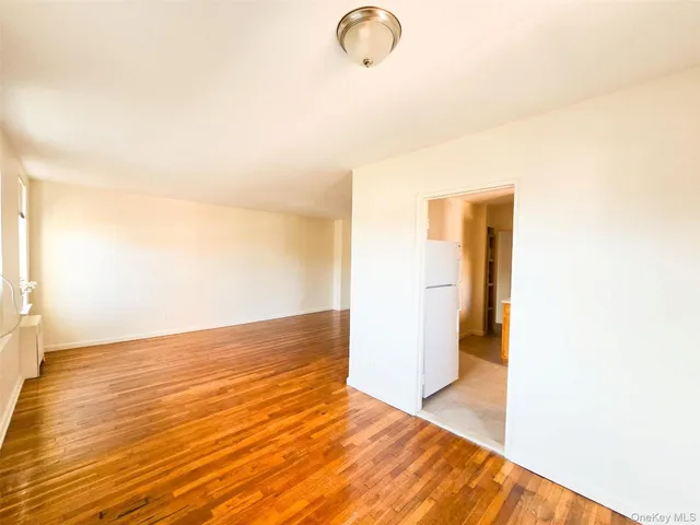 a view of a room with wooden floor
