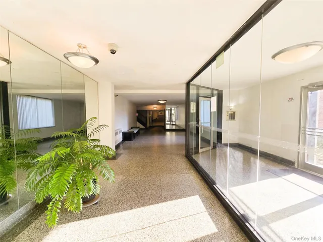 a lobby with furniture and a potted plant