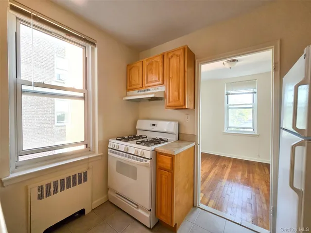 a kitchen that has a stove and a window