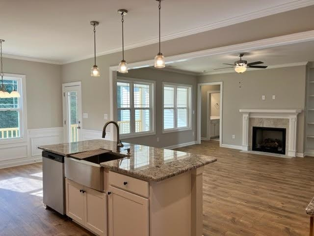 378 Lowery Lane Benson, NC 27504 - Photo 14 of 31 a kitchen with granite countertop a stove and a sink with wooden floor