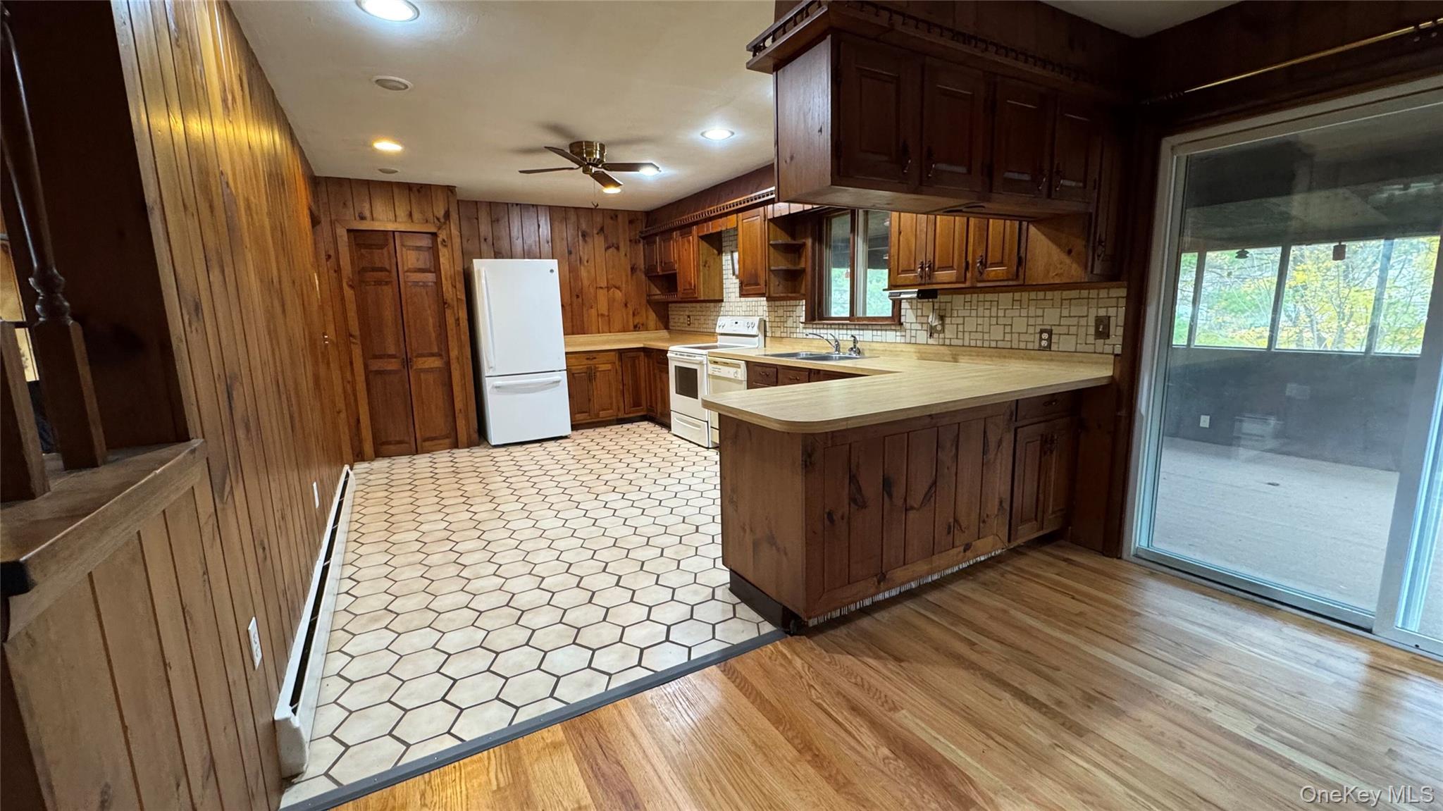 107 Noxon Road Poughkeepsie, NY 12603 - Photo 14 of 38 a kitchen with stainless steel appliances granite countertop a sink stove and wooden floor