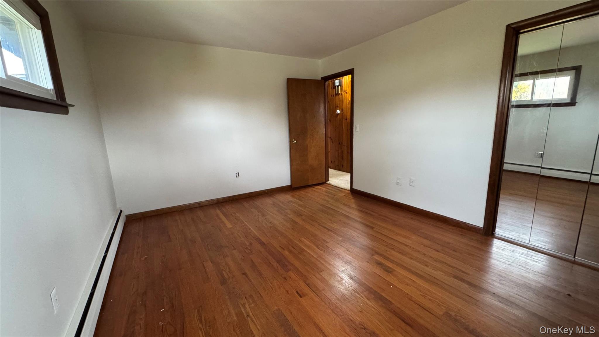 107 Noxon Road Poughkeepsie, NY 12603 - Photo 20 of 38 a view of an empty room with wooden floor and a window