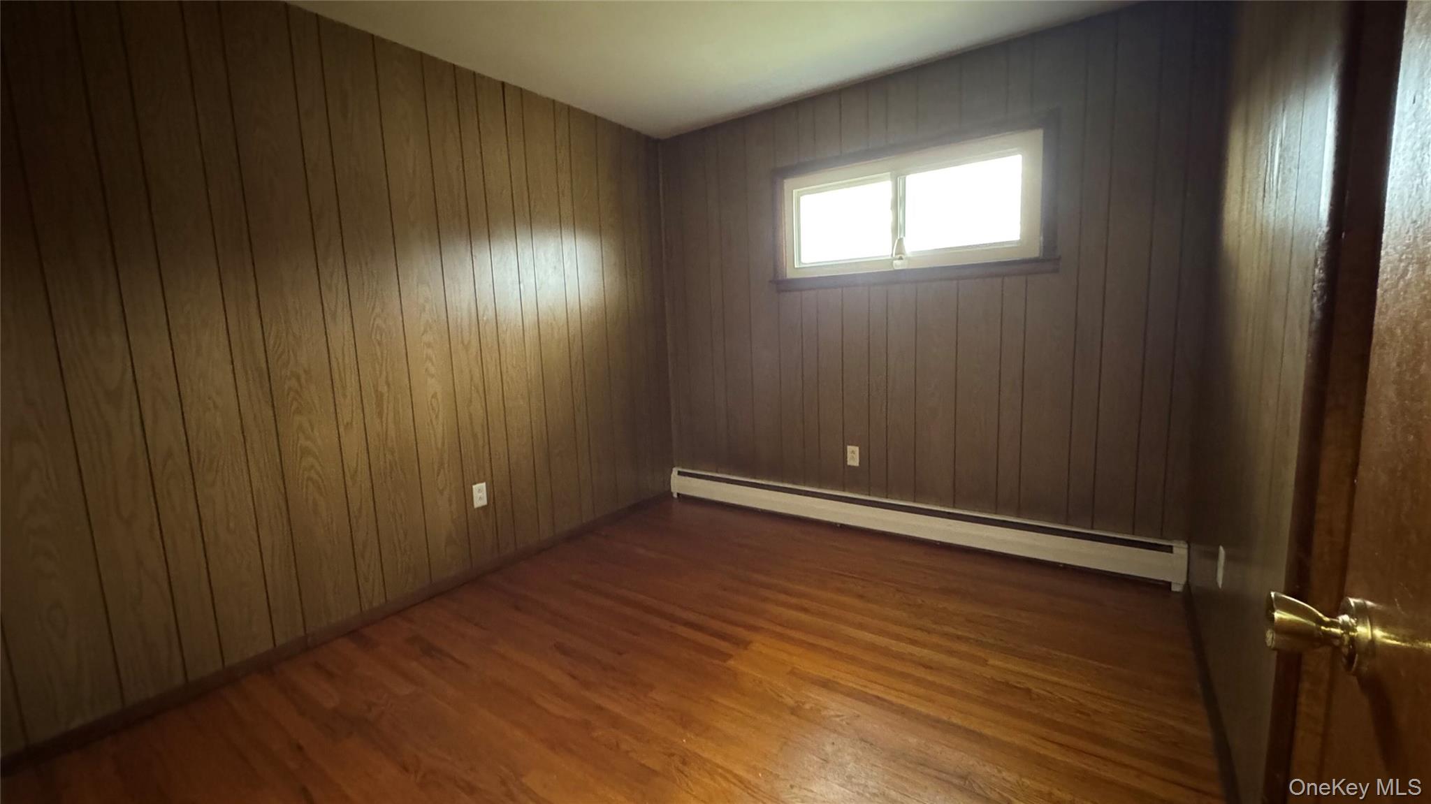 107 Noxon Road Poughkeepsie, NY 12603 - Photo 21 of 38 an empty room with wooden floor and windows