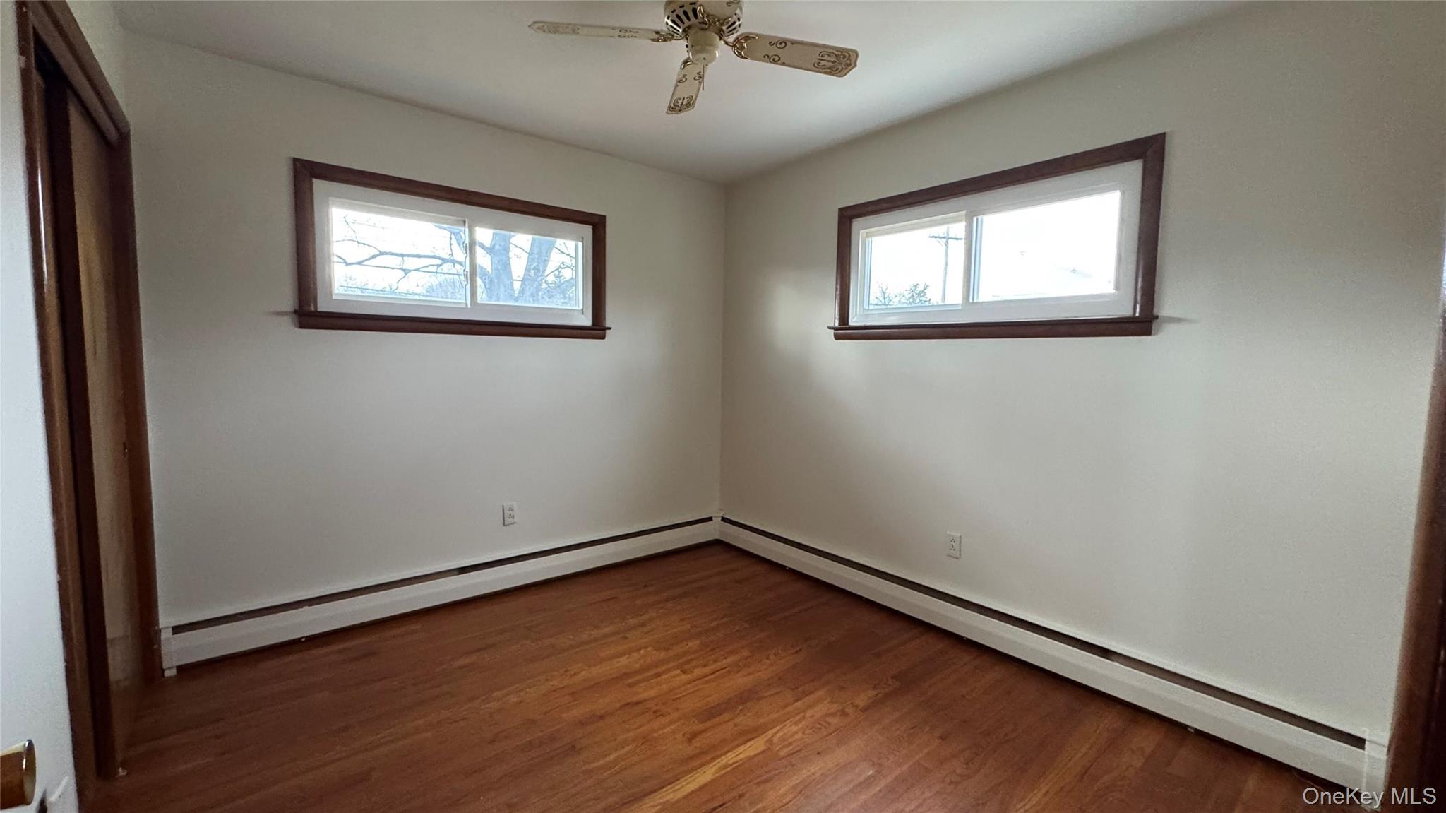 107 Noxon Road Poughkeepsie, NY 12603 - Photo 23 of 38 an empty room with wooden floor chandelier and windows
