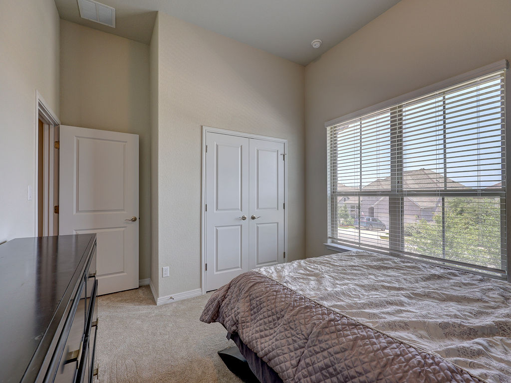 229 Heartleaf Road San Marcos, TX 78666 - Photo 37 of 40 A well-lit sleeping area features vaulted ceilings, ample closet space, and soft carpet.