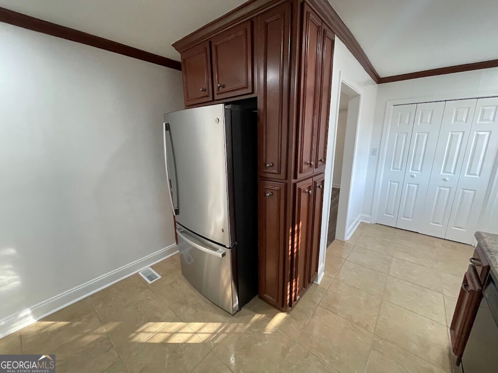 2311 St George Lane Albany, GA 31707 - Photo 15 of 39 a view of a refrigerator in kitchen and an empty room