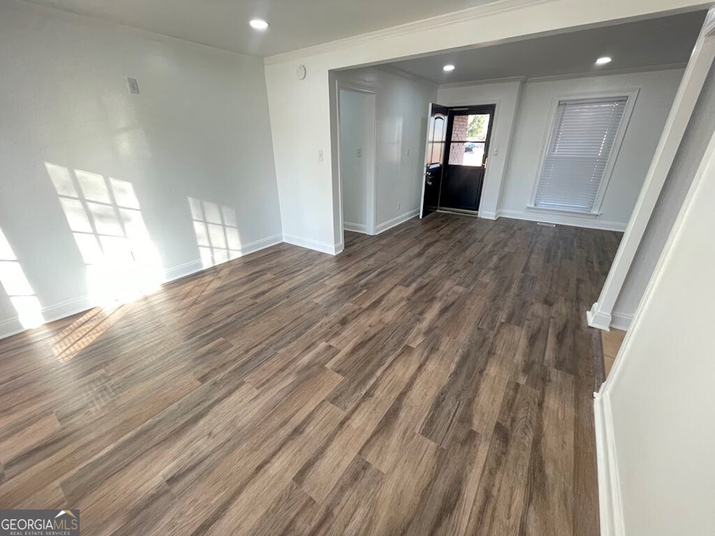 2311 St George Lane Albany, GA 31707 - Photo 2 of 39 an empty room with wooden floor and windows