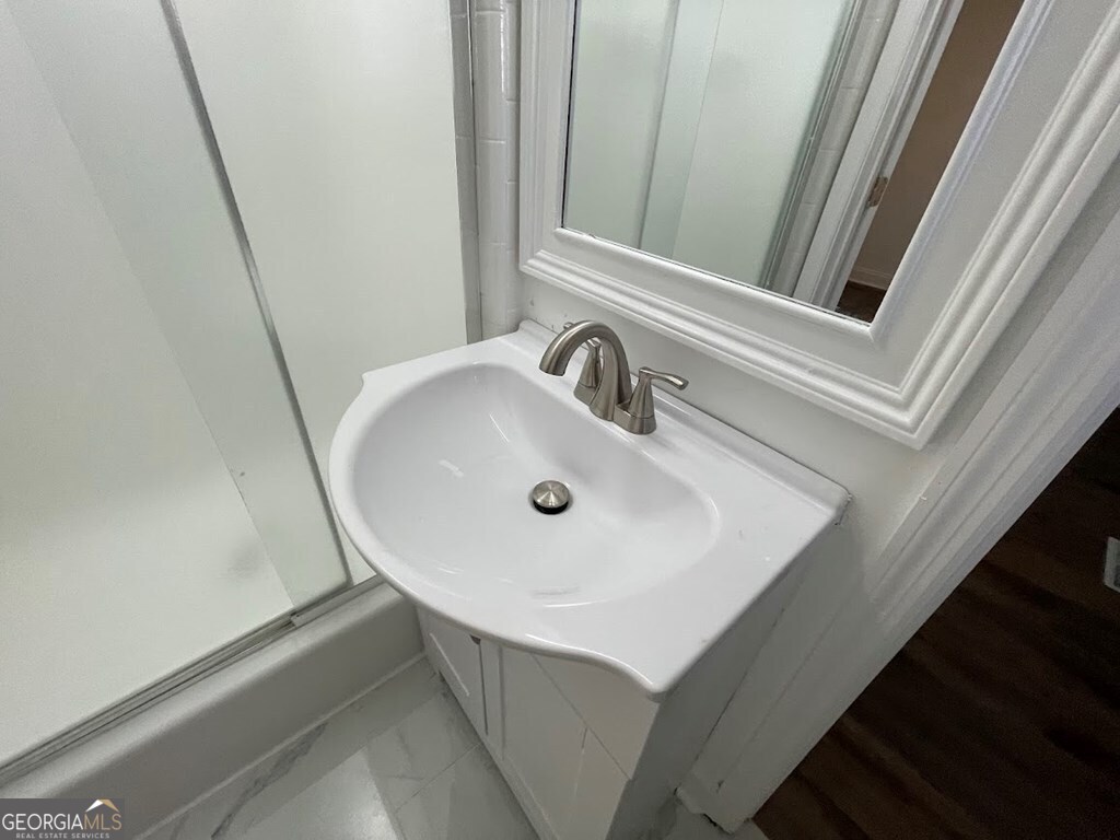 2311 St George Lane Albany, GA 31707 - Photo 21 of 39 a bathroom with a sink and a mirror