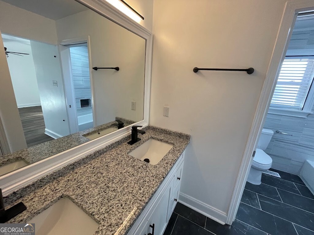 2311 St George Lane Albany, GA 31707 - Photo 26 of 39 a bathroom with a granite countertop sink and a mirror