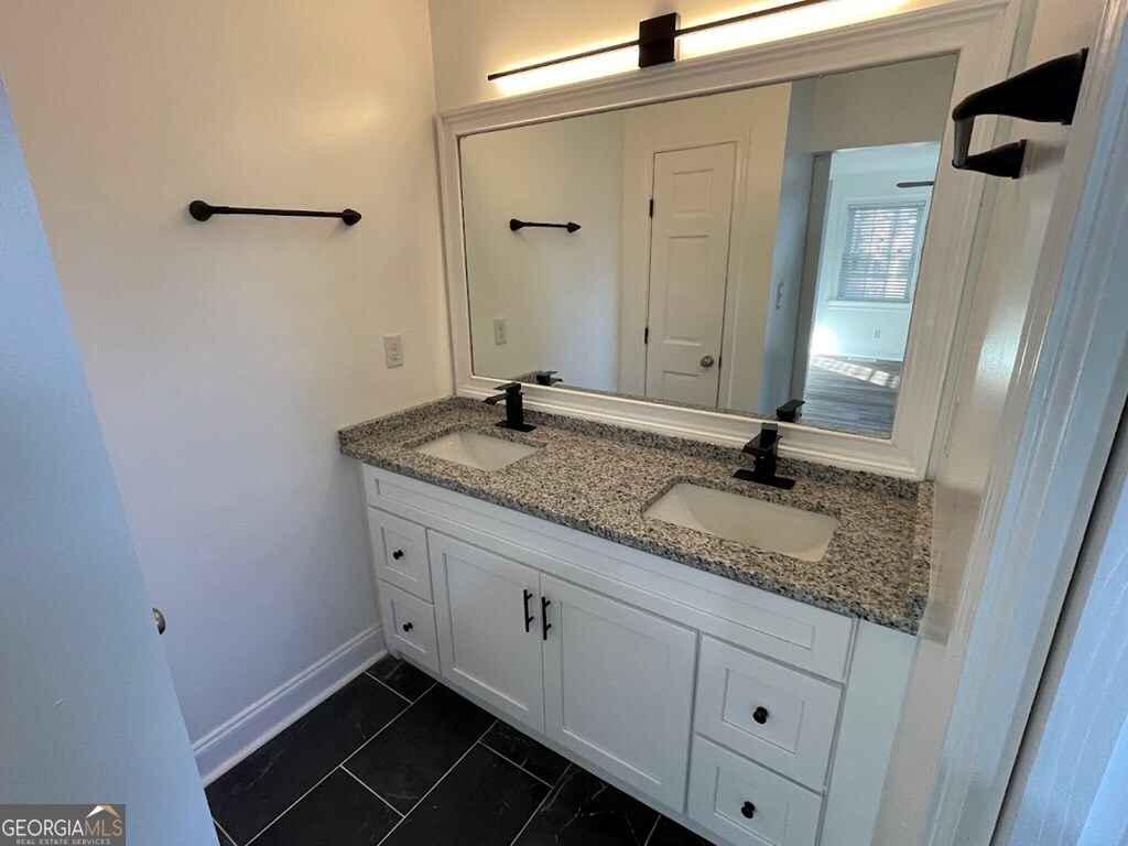 2311 St George Lane Albany, GA 31707 - Photo 27 of 39 a bathroom with a granite countertop sink and a mirror