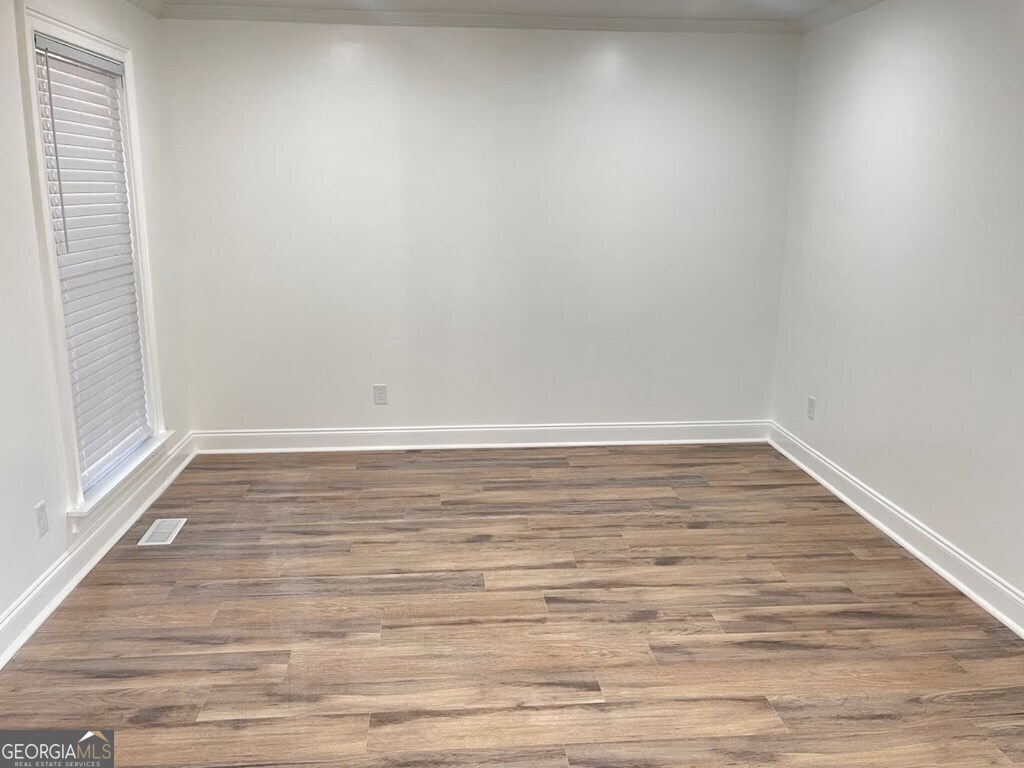 2311 St George Lane Albany, GA 31707 - Photo 3 of 39 a view of an empty room with wooden floor