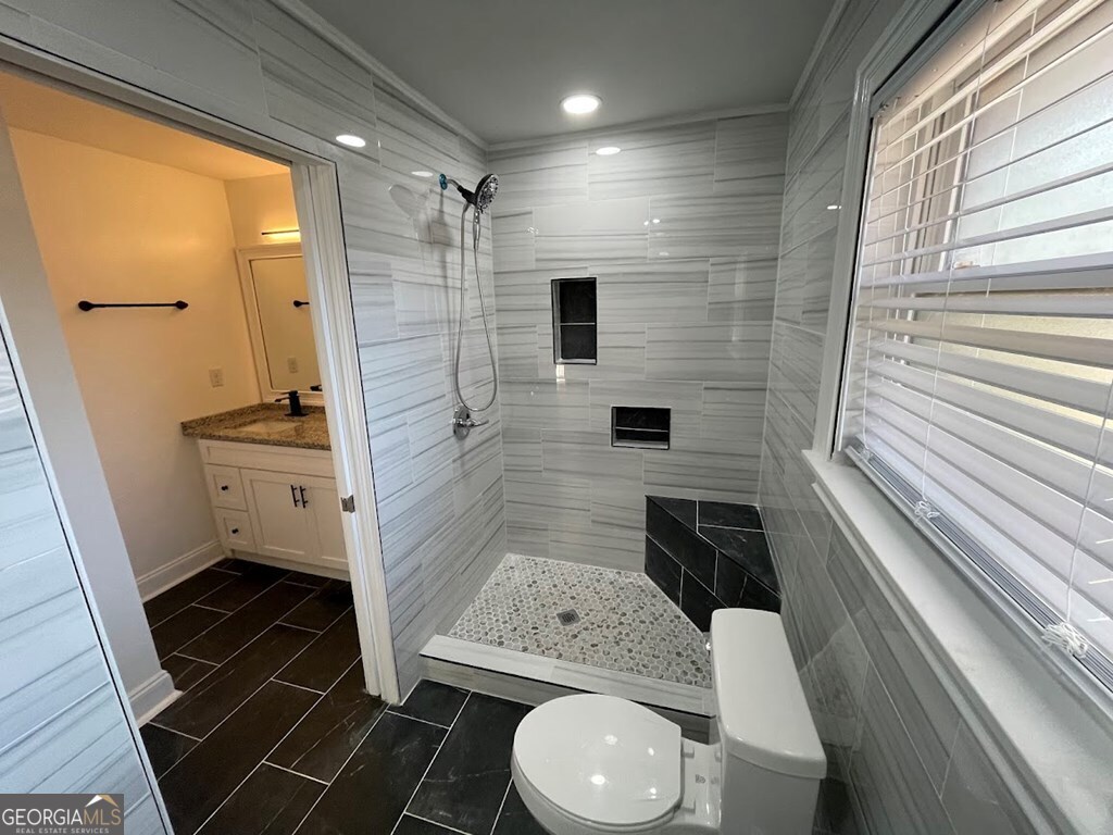 2311 St George Lane Albany, GA 31707 - Photo 31 of 39 a bathroom with a sink a toilet a mirror and shower