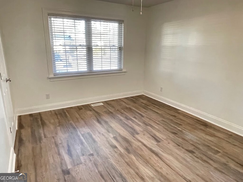 2311 St George Lane Albany, GA 31707 - Photo 33 of 39 an empty room with wooden floor and windows
