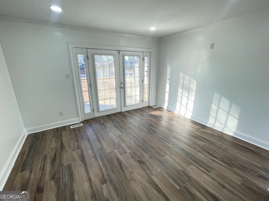 2311 St George Lane Albany, GA 31707 - Photo 8 of 39 wooden floor in an empty room with a window