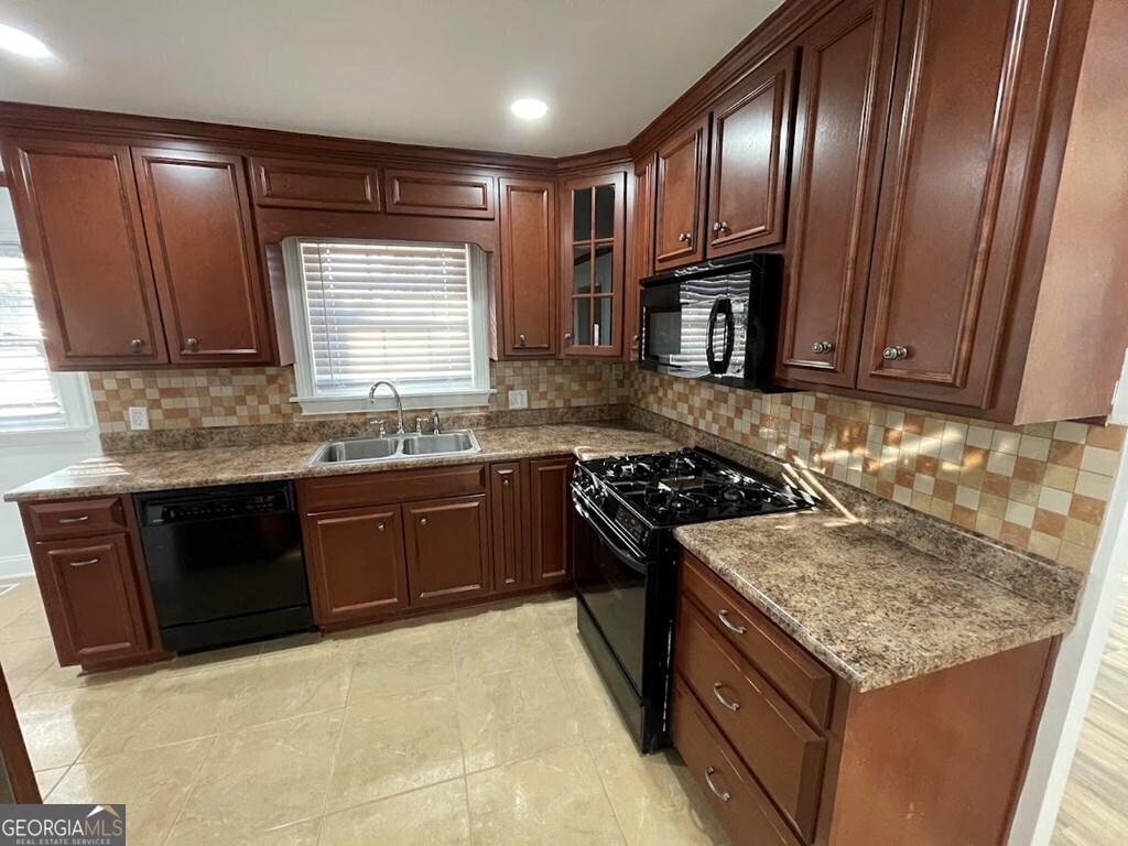 2311 St George Lane Albany, GA 31707 - Photo 9 of 39 a kitchen with granite countertop stainless steel appliances and wooden cabinets