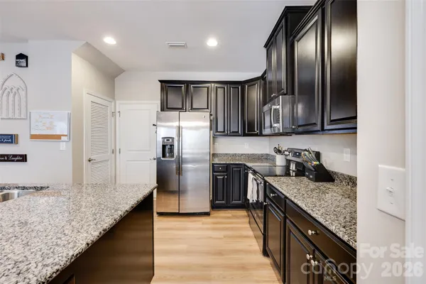 a kitchen with granite countertop stainless steel appliances and wooden cabinets
