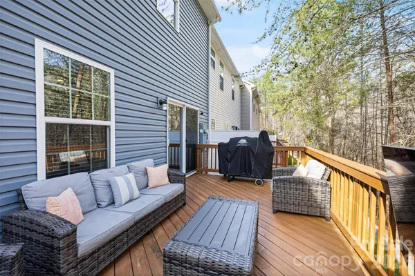 a balcony with wooden floor and furniture