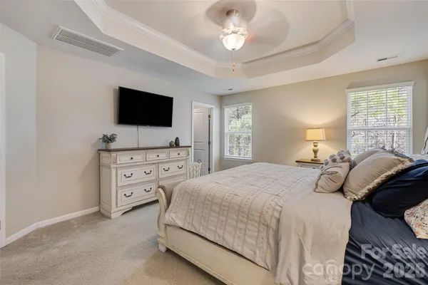a bedroom with a bed and a chandelier
