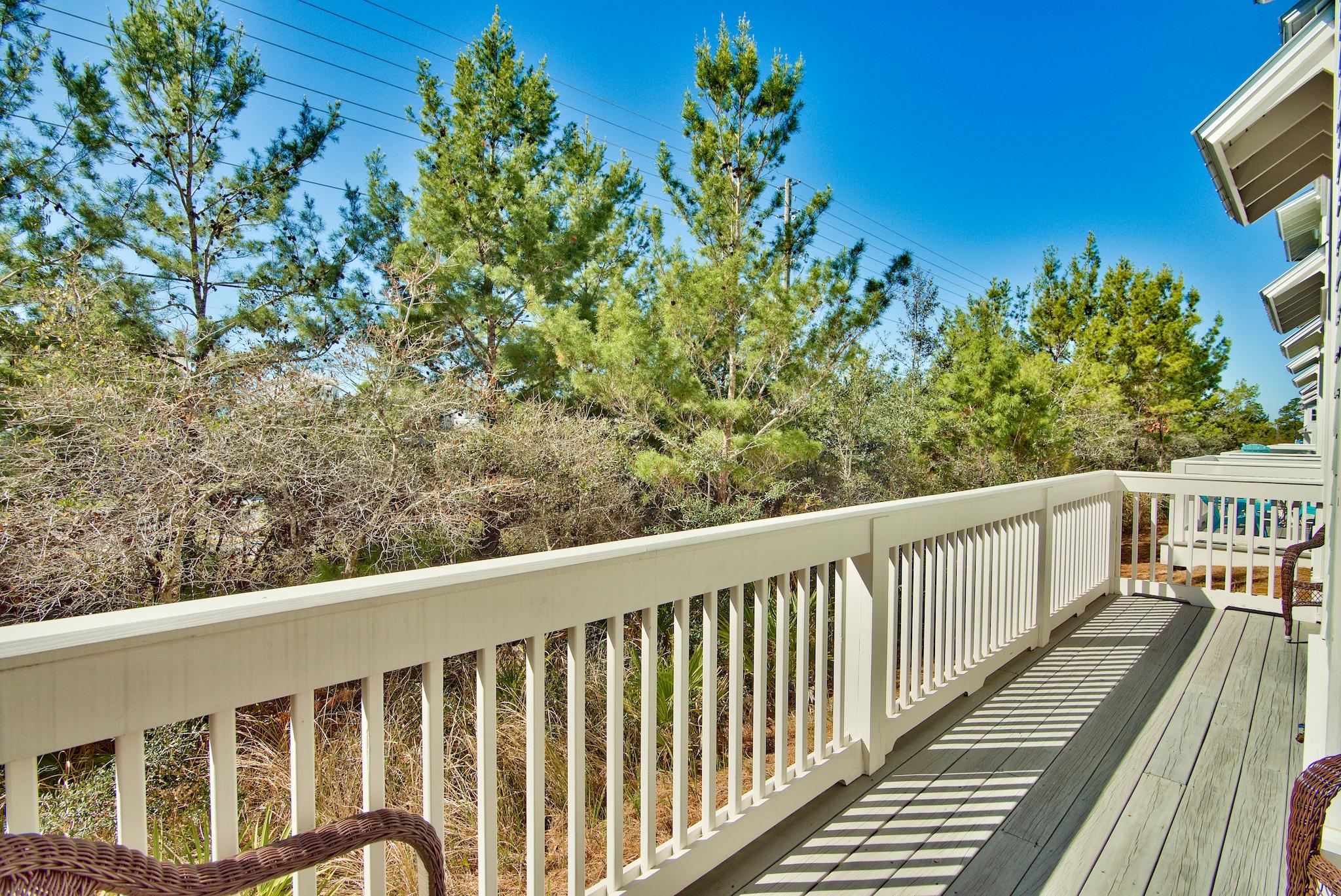 18 Milestone Drive Inlet Beach, Unit A Inlet Beach, FL 32461 - Photo 18 of 39 a balcony with wooden floor and fence
