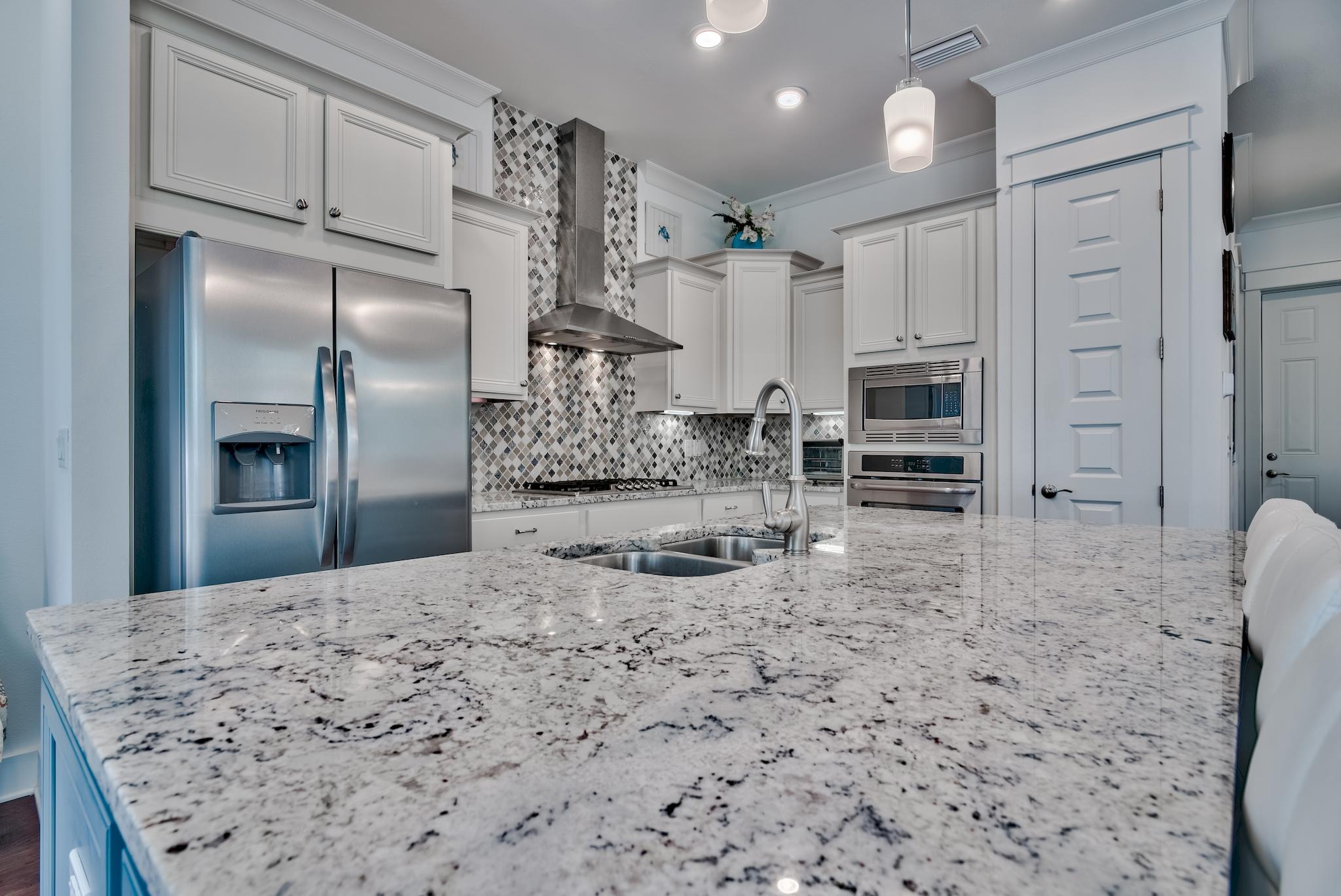 18 Milestone Drive Inlet Beach, Unit A Inlet Beach, FL 32461 - Photo 6 of 39 a kitchen with kitchen island a sink stainless steel appliances and cabinets