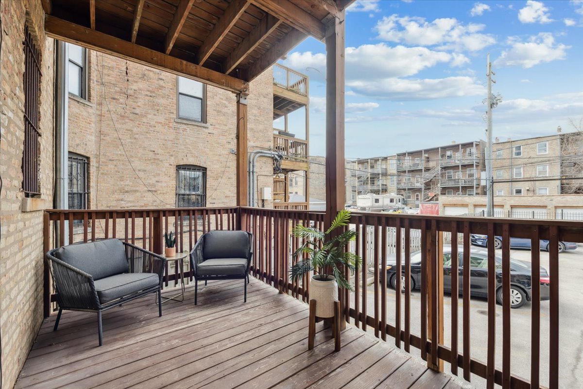 4028 North Sheridan Road, Unit 1R Chicago, IL 60613 - Photo 11 of 15 a balcony with wooden floor outdoor seating