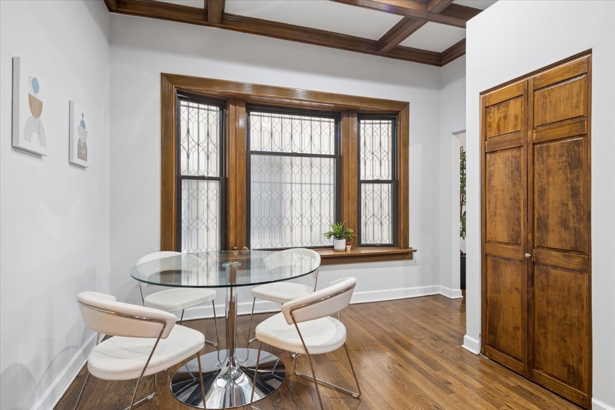 4028 North Sheridan Road, Unit 1R Chicago, IL 60613 - Photo 7 of 15 a dining room with wooden floor and large window