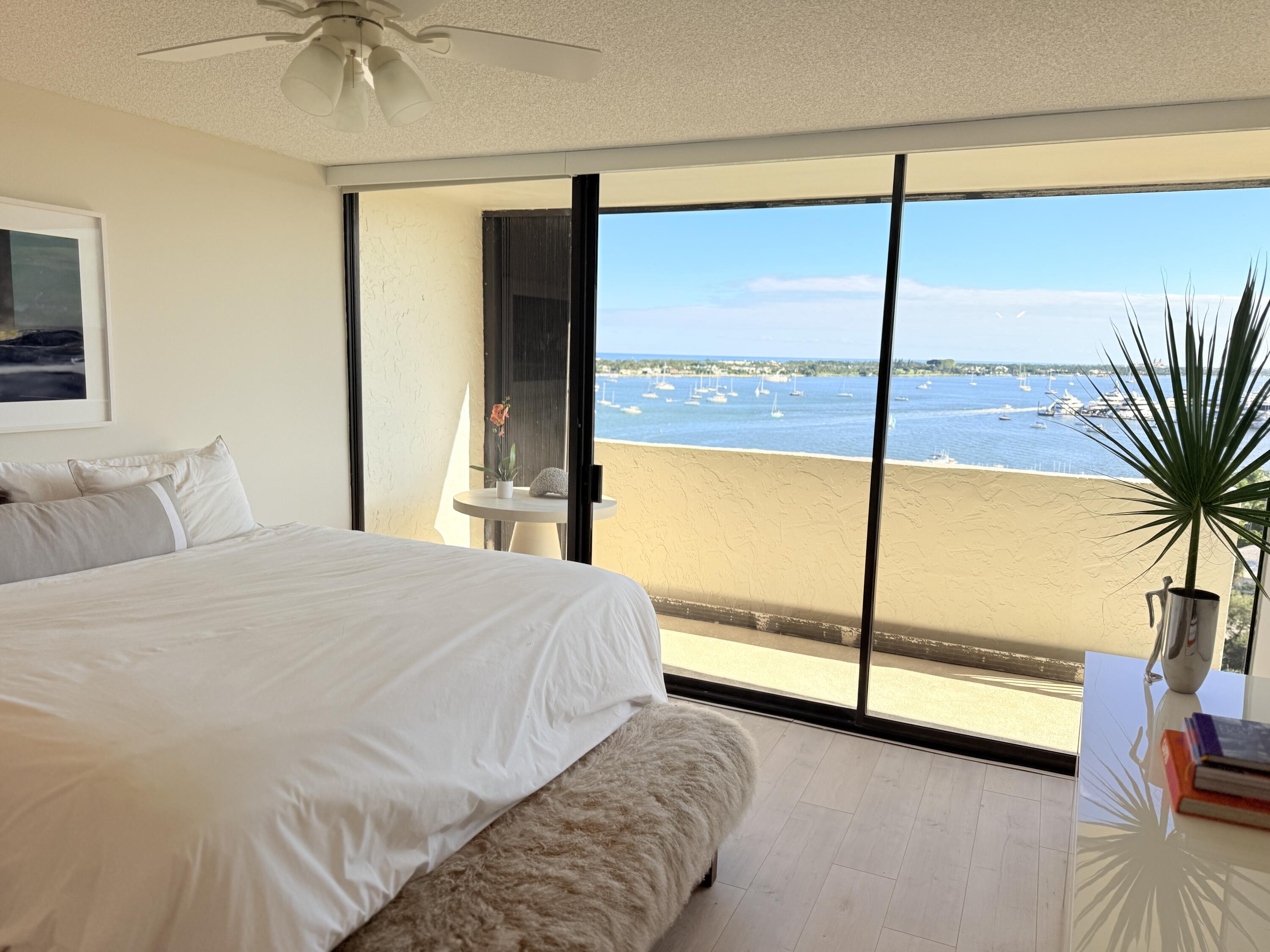 5200 North Flagler Drive, Unit 1406 West Palm Beach, FL 33407 - Photo 18 of 31 a bedroom with a large window and a bed