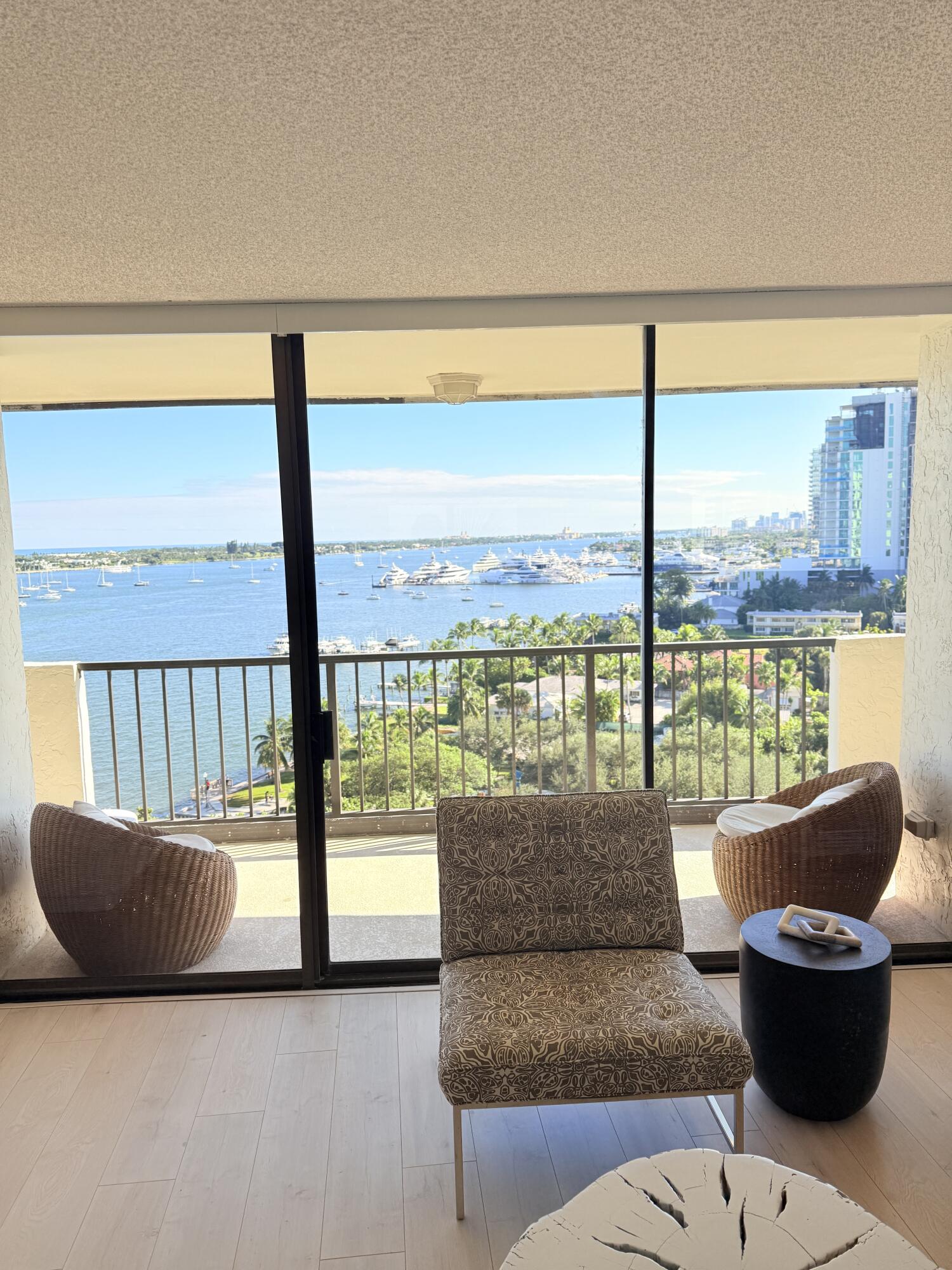 5200 North Flagler Drive, Unit 1406 West Palm Beach, FL 33407 - Photo 2 of 31 a living room with furniture and a floor to ceiling window
