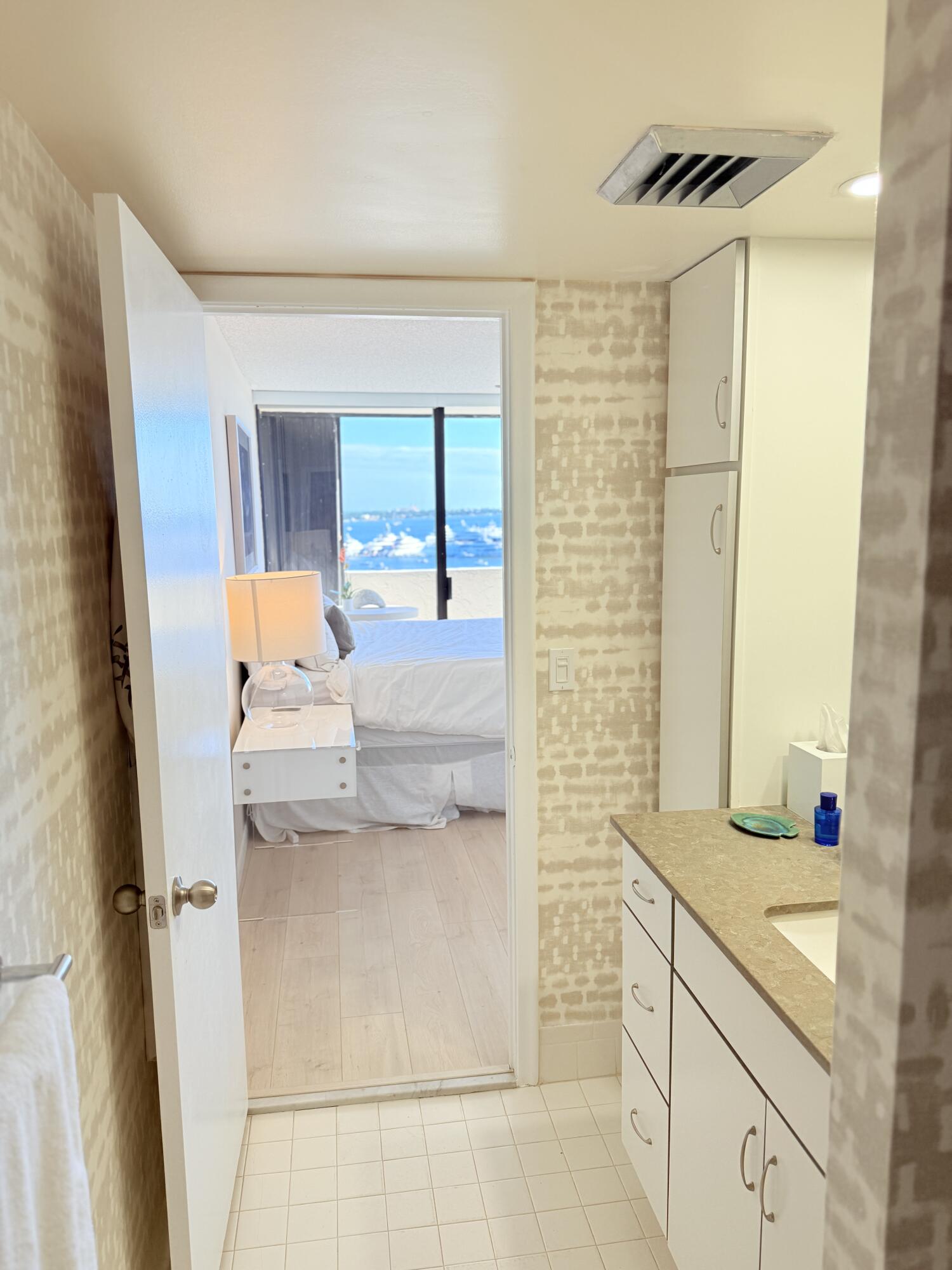 5200 North Flagler Drive, Unit 1406 West Palm Beach, FL 33407 - Photo 24 of 31 a bathroom with a granite countertop sink and a mirror