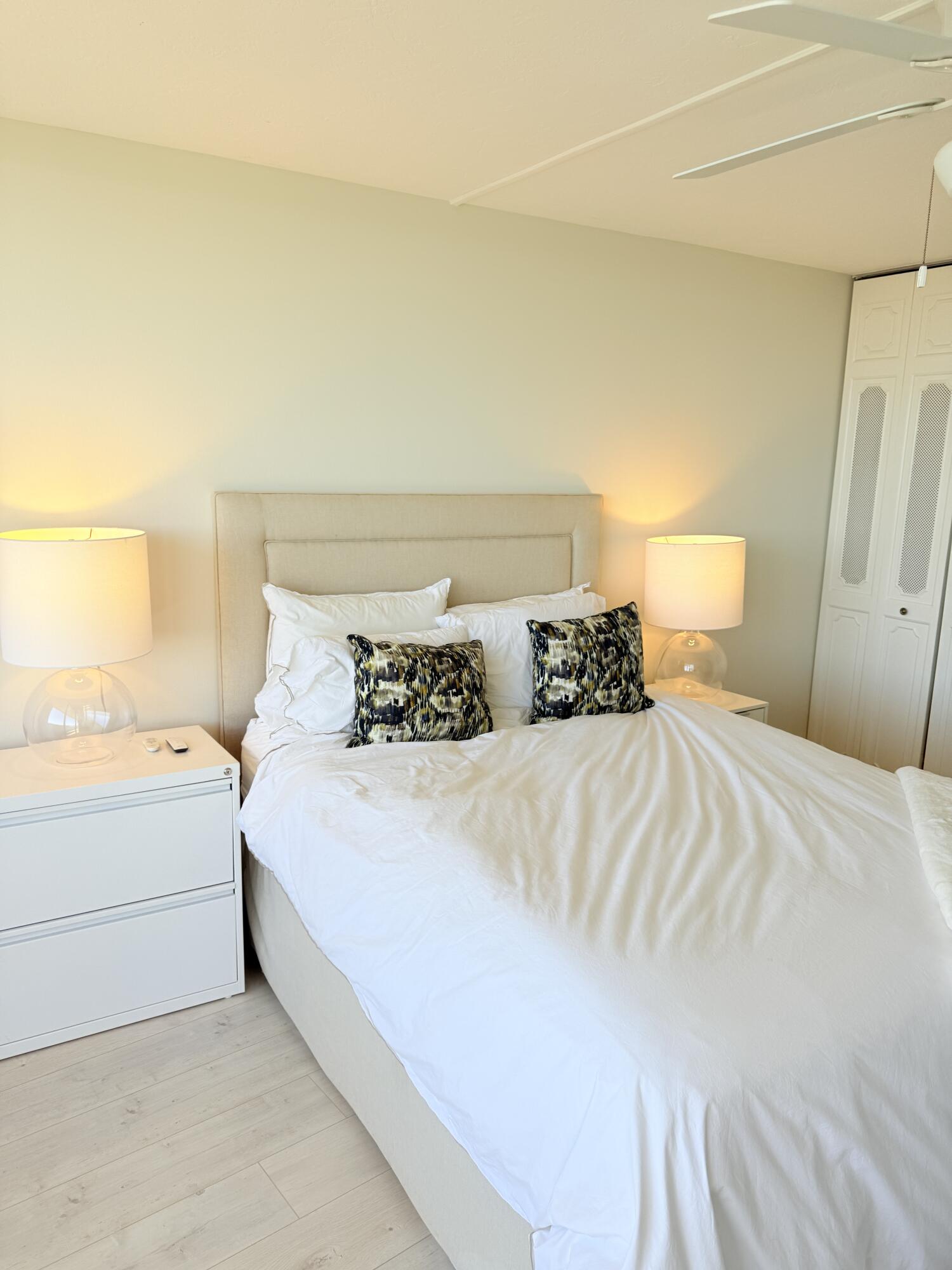 5200 North Flagler Drive, Unit 1406 West Palm Beach, FL 33407 - Photo 26 of 31 a bedroom with a bed and a night stand