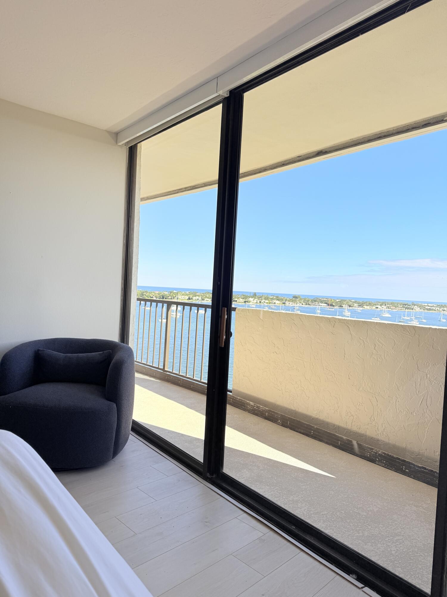 5200 North Flagler Drive, Unit 1406 West Palm Beach, FL 33407 - Photo 27 of 31 a living room with furniture and a floor to ceiling window
